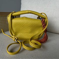 Original Bag From The Store Never Worn Perfect Condition Leather Unique Detailed Tassel In The Side Yellow Pouch Bag For Shopping, Yellow Rectangular Bucket Bag With Handles, Yellow Satchel Shoulder Bag With Detachable Strap, Luxury Yellow Crossbody Satchel, Yellow Pouch Bag With Detachable Handle, Yellow Crossbody Bucket Bag For Daily Use, Yellow Rectangular Shoulder Bag With Detachable Strap, Yellow Pouch Shoulder Bag With Adjustable Strap, Yellow Shoulder Bag With Double Handle