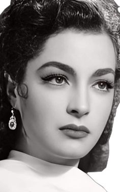 a black and white photo of a woman with curly hair wearing large earrings on her head