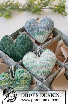 several knitted hearts are in a box