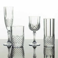 a group of glasses sitting on top of a table next to each other in front of a white background