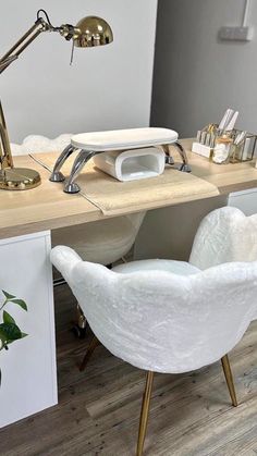 a white chair sitting in front of a desk with a phone on top of it