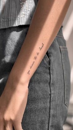 a woman's arm with a small tattoo that reads, i love you to the moon and back