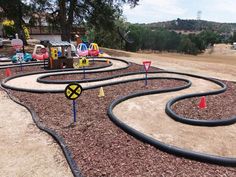 an outdoor play area with various toys on the ground