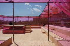 the inside of a building with pink walls and wooden flooring on top of it