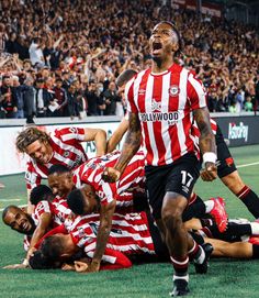 a group of men standing on top of a soccer field