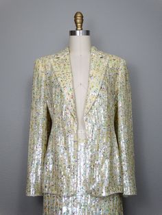 "This is a RARE and AMAZING vintage dress suit! Both pieces are beautifully detailed with sequins all over and accented with beading along the hems. It's in PERFECT condition! Note, measurements are taken with the front brought together, there are no closures on the blazer. Bust - will fit up to 38\" Shoulders - 16\" Sleeves - 24.5\" Length of Jacket - 26\" Skirt Waist - 27\" Hips - 38\" Length of Skirt - 23\" Tag Size - 4 This item comes from a pet-free and smoke-free home. If you would like mo Checkered Jacket, Bead Sewing, Sequined Dress, Skirt Suit Set, Sequin Jacket, Beaded Gown, Vintage Couture, Dress Suit, Couture Gowns