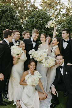 a bride and groom posing with their bridal party