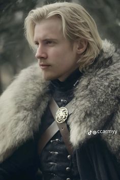 a man with long blonde hair wearing a fur collar