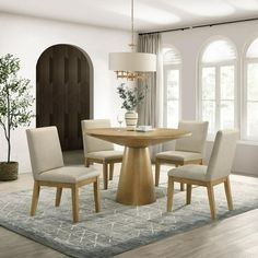 a dining room table with beige chairs around it