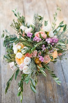 a bouquet of flowers sitting on top of a wooden table