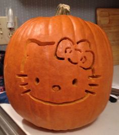 a hello kitty pumpkin carved to look like it is smiling