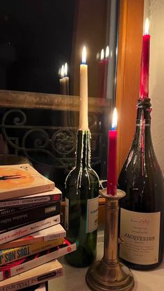 there are many books and wine bottles on the table