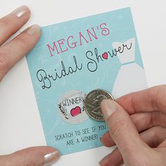 two hands are holding a card with a coin in front of it that says, megan's bridal shower