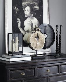 there is a clock on top of a dresser