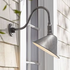 an outdoor light on the side of a house