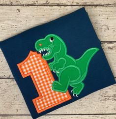 Dinosaur Birthday Shirt, Dinosaur Birthday, Dino Shirt:  Super Cute Applique Number with a TRex!  Absolutely adorable!  Perfect for a Dinosaur Birthday! Colors and fabrics are completly customizable - choose whatever style or colors you need/want. This shirt is completely customizable to whatever colors you like -great gift idea or just because it is cute item.  Included is the addition of your child's name.  Many more fabrics available. View Available Fabrics and Fonts at www.emmylouchildrens.com. Upon checkout, please provide the following: 1. Size of TShirt; 2. Number Choice (if applicable); 3. Name (if desired) and color 4. Fabric Choices. An email will be sent confirming order prior to any work beginning.  Please allow 1-2 weeks for item to ship:  If needed sooner, please convo me, de Ballet Mom Shirt, Birthday Colors, Dance Team Shirts, Dance Mom Gifts, Boys Birthday Outfits, 1st Birthday Shirt, Lion Birthday, Dance Mom Shirts, First Birthday Shirt