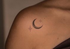 a woman with a crescent and star tattoo on her shoulder