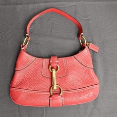 Coach Hampton Coral Pebbled Leather Clip Hobo Shoulder Bag Introducing The Coach Hampton Coral Leather Clip Hobo Shoulder Bag, A Vintage Gem That Exudes Elegance And Style. This Rare Find Is In Excellent Condition, Having Been Well-Preserved Over The Years. The Vibrant Coral Leather Exterior Is Eye-Catching And Adds A Pop Of Color To Any Ensemble. The Bag Features A Convenient Clip Closure, Keeping Your Belongings Secure While Adding A Touch Of Sophistication. The Hardware Of This Vintage Bag Shows Light Signs Of Wear, Which Is Expected From A Pre-Loved Item. This Minor Wear Does Not Detract From The Overall Appeal Of The Bag And Adds A Hint Of Character. The Spacious Interior Of The H Hobo Shoulder Bag, Vintage Bag, Vintage Bags, Cute Bag, Hobo Bag, Pebbled Leather, Coach Bags, The Hamptons, Color Pop