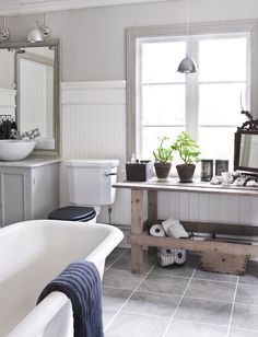 a bathroom with a tub, sink and mirror