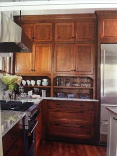 a kitchen with wooden cabinets and stainless steel appliances