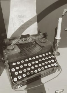 an old fashioned typewriter sitting on top of a table