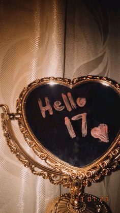 a mirror with writing on it that says hello 17 in gold frame and is hanging from the wall