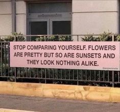 a sign on the side of a building that says stop comparing yourself flowers are pretty but so are sunsets and they look nothing alike