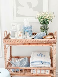 a wicker shelf with towels, soaps and other personal care items on it