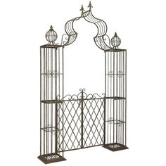 a wrought iron garden trellis with two birdcages on each side and an open door