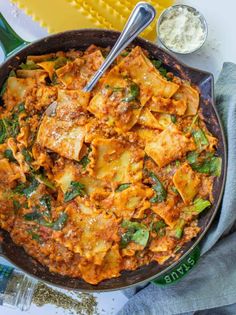 a skillet filled with pasta and vegetables