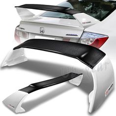 the rear end of a white car with black carbon fiber fenders and tail lights