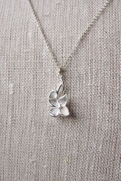 Sterling Silver Dogwood Flower Necklace, No. BSRC023 :*About This Piece*: ♦︎ An elegant recreation of one of spring's loveliest blossoming trees, this sterling silver dogwood blossom pendant is hung on sterling silver rolo chain. The flowering pendant is gorgeous, solid sterling silver. ♦︎ Length - 18 in (45.7 cm) chain ♦︎ Pendant - .47 in (12 mm) x .9 in (23 mm) ♦︎ All items from my shop are packaged in padded cardboard jewelry boxes. Custom gifting options available upon request. ♦︎ Are you lo Etsy Necklace, Dogwood Flower, Freshwater Pearl Drop Earrings, Dogwood Flowers, Cardboard Jewelry Boxes, Wood Necklace, Freshwater Pearls Earrings, Swarovski Crystal Earrings, Handcrafted Necklace