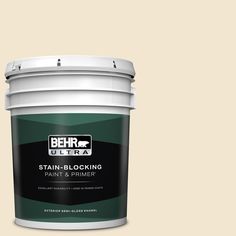 the behr ultra stain - blocking paint and primer is shown in an open bucket