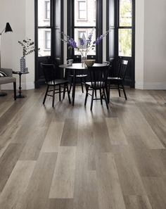 a dining room with wood floors and white walls