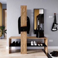 a wooden bench sitting in front of a mirror next to shoes and purses on the floor