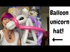 a woman is holding up an inflatable balloon unicorn that looks like a dog