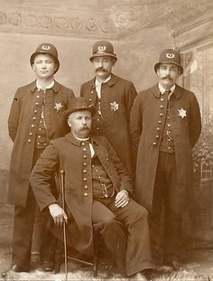 an old time photo of men in uniforms