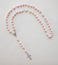 This listing includes (1) rosary. Acrylic pink beads with detailed Crucifix 1-1/2" long. SIZE/LENGTH: Total length is 22" including the Crucifix BEADS: Quality 8 mm (5/16") acrylic round beads carefully assembled on a zinc alloy chain. CENTER:  Zinc alloy center piece of The Madonna measures 1/2" x 5/8" CRUCIFIX: The Crucifix measures 1-1/2" L x 7/8" W. ALL LINKS HAVE BEEN CHECK ONE BY ONE BEFORE SHIPPING THIS ROSARY...HOWEVER IT HAS NOT BEEN DESIGNED TO USE AS A NECKLACE ROSARY AND YOU SHOULD INSTEAD USE CORD ROSARIES FOR THIS PURPOSE. HOWEVER IF YOU DECIDE TO USE IT AS A NECKLACE ROSARY WE WILL NOT BE RESPONSIBLE FOR ANY DAMAGE AND WE DON'T RECOMMEND IT Come Visit Us at Our New Store! Please feel free to email me with questions about this item. Also please check my other listings. I am a Pink Rosary With 8mm Round Beads, Pink Beaded Rosary With Round Beads, Pink 8mm Beads Crucifix Jewelry, Pink Rosary With Round Beads For First Communion, Pink Beaded Rosary, Pink Rosary For First Communion, Adjustable Pink Cross Rosary, Pink Rosary, Acrylic Pink