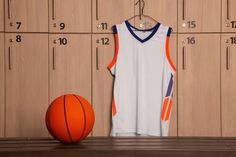 a basketball and jersey hanging in front of lockers