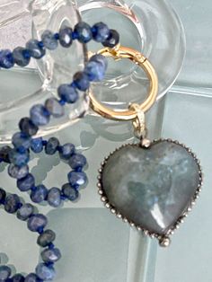 This is a beautiful hand-knotted Lapis Lazuli Rondelle semi-precious stone necklace with a large Labradorite Heart Shaped Pendant. These pendants are made from natural stones and each one is unique and beautiful, so it is not guaranteed you will receive the exact stone pictured. The Pendant is removable and has a micro pave bale . Please see photographs. Wear the necklace with or without the pendant. A true statement piece. Approximate size of pendant is 42mm x 40mm x 17mm: The length of the nec Blue Hand Knotted Jewelry For Gift, Blue Hand-knotted Jewelry For Gift, Artisan Hand Knotted Necklace For Gift, Artisan Hand Knotted Jewelry For Gifts, Artisan Hand Knotted Jewelry As A Gift, Artisan Hand-knotted Jewelry For Gifts, Heart Shaped Pendant, Stone Pictures, Heart Shape Pendant