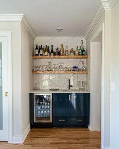 a kitchen with marble counter tops and blue cabinetry, along with an area rug on the floor