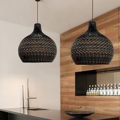 two black lights hanging from the ceiling in a room with wood paneling and cabinets