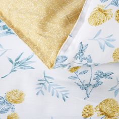 the yellow and blue flowered sheets are folded together