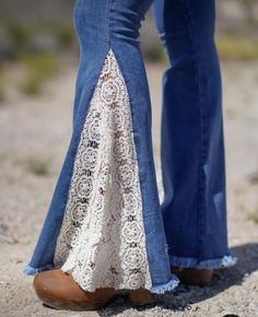 the legs of two people wearing jeans and brown shoes with lace on them, standing next to each other