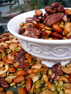 nuts and pistachios in a white bowl