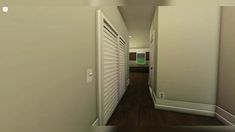 an empty hallway with shutters on the doors and hard wood flooring is seen in this image