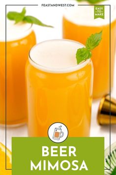 two glasses filled with orange juice and garnished with mint leaves on the side