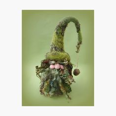 a green gnome's hat is hanging from a string