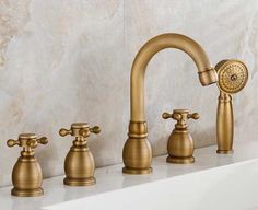 three faucets are lined up on the counter