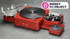 a red record player sitting on top of a table